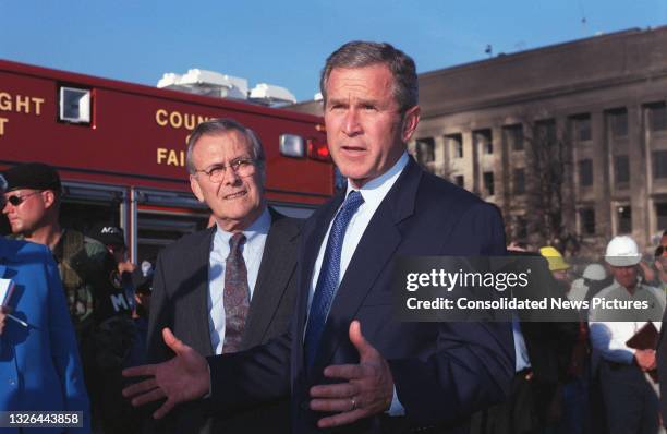 Secretary of Defense Donald Rumsfeld listens US President George W Bush makes a late afternoon visit to the Pentagon, Washington DC, September 12,...