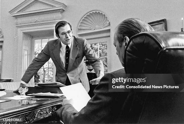 View, from behind the President's desk, of Chief of Staff Donald Rumsfeld and US President Gerald Ford in the White House's Oval Office, Washington...