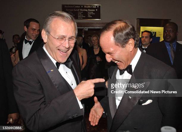 Secretary of Defense Donald Rumsfeld and newspaper & magazine publisher Mortimer Zuckerman share a laugh as they arrive at the White House...
