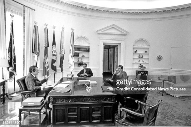 President Richard Nixon sits with members of his senior staff in the White House's Oval Office, Washington DC, April 21, 1969. Pictured are, from...