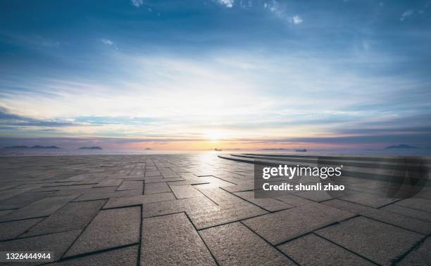 an empty square by the sea at sunrise - liaoning province stock pictures, royalty-free photos & images