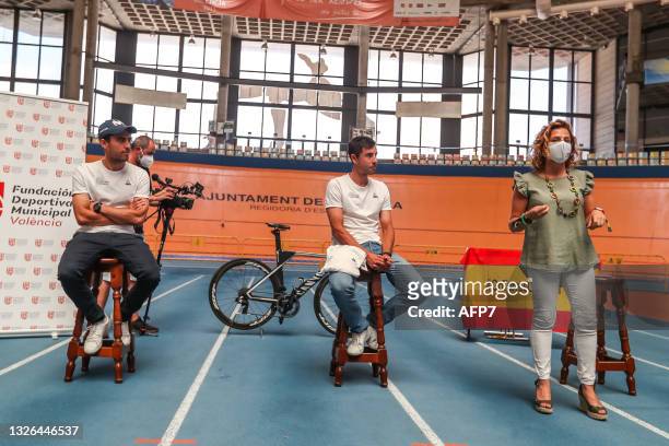 Albert Torres and Sebastian Mora, cyclists with the Spanish Track Team, and Pilar Bernabe, Delegate Councilor for Sports in Valencia, attend during...