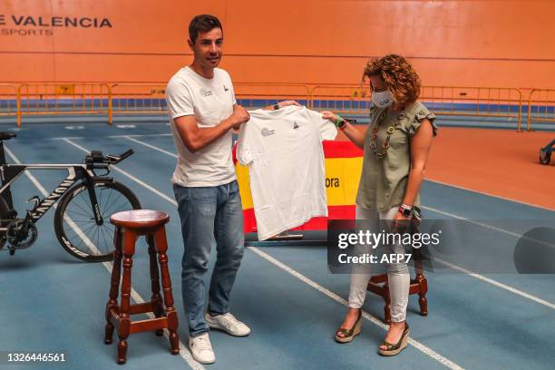 Sebastian Mora a cyclist with the Spanish Track Team, and Pilar Bernabe, Delegate Councilor for Sports in Valencia, pose for photo during the...