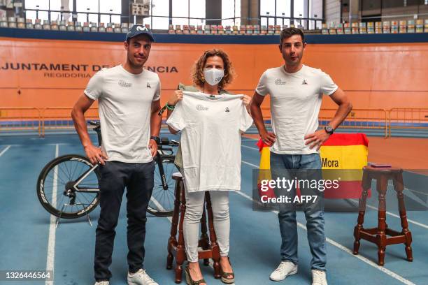 Albert Torres and Sebastian Mora, cyclists with the Spanish Track Team, and Pilar Bernabe, Delegate Councilor for Sports in Valencia, pose for photo...