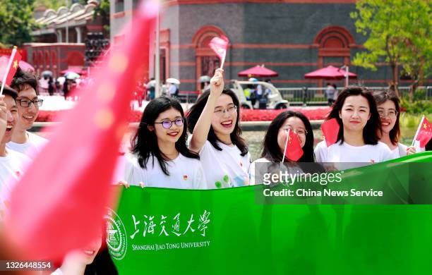 People pose for a photo outside the memorial of the first National Congress of the Communist Party of China on July 1, 2021 in Shanghai, China.