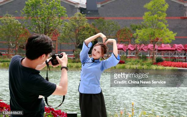 Tourist poses for a photo outside the memorial of the first National Congress of the Communist Party of China on July 1, 2021 in Shanghai, China.