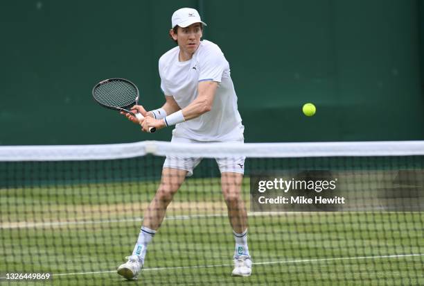 John-Patrick Smith of Australia, playing partner of Matthew Ebden of Australia plays a backhand during their men's doubles first round match against...