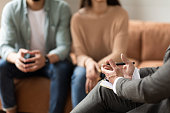 Couple talking at session with male therapist
