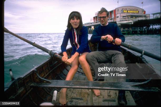 Actress Anita Harris and comedian Roy Hudd rowing a boat in the water around Bournemouth Pier Theatre, circa 1969.