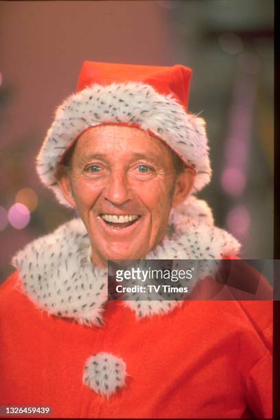 Singer and actor Bing Crosby dressed as Santa Claus on the set of his holiday special Bing Crosby's White Christmas, circa 1976.