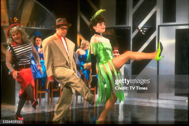 Comic performers Ernie Wise and Eric Morecambe filming a dance routine, likely on The Morecambe & Wise Show, circa 1984. Also present is actress Jane...