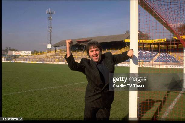 Radio and television presenter Danny Baker photographed at Millwall F.C.'s home stadium, better known as The Den, circa 1988.