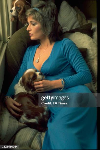 Actress Stephanie Beacham photographed with her two King Charles Spaniels, circa 1974.