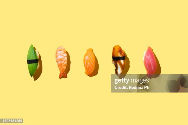 food photo sushi with shrimp, avocado, salmon, tuna, eel on plate in trendy color block style. top view. flat lay. - sushi stock pictures, royalty-free photos & images
