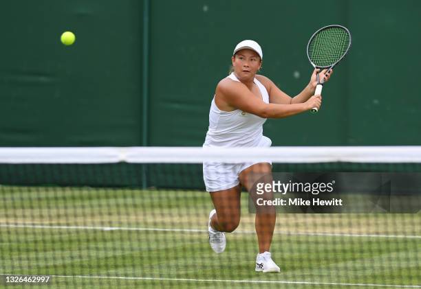 Tara Moore of Great Britain, playing partner of Eden Silva of Great Britain plays a forehand during her Ladies' Doubles First Round match against...