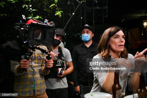 Cameramen Aaron Wise and Rigel “Che” Yaluk film actor Amy Motta during production of the indie feature film, “The Star City Murders” on July 01, 2021...