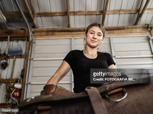 young female trainer doing chores - female jockey stock pictures, royalty-free photos & images
