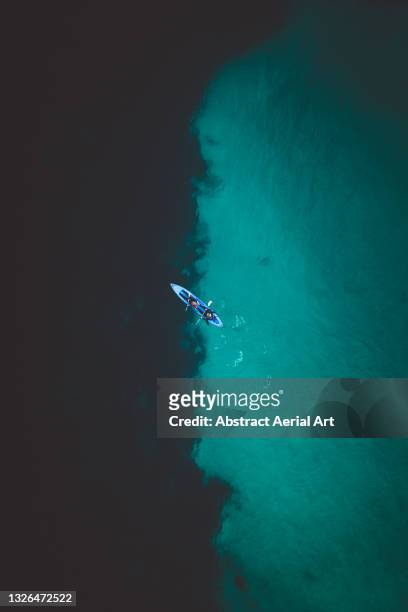 drone shot above a kayak on the ocean, newquay, cornwall, united kingdom - atlantic ocean bildbanksfoton och bilder