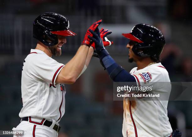 Ozzie Albies reacts with Ender Inciarte of the Atlanta Braves after his three run home run in the eighth inning of an MLB game against the New York...