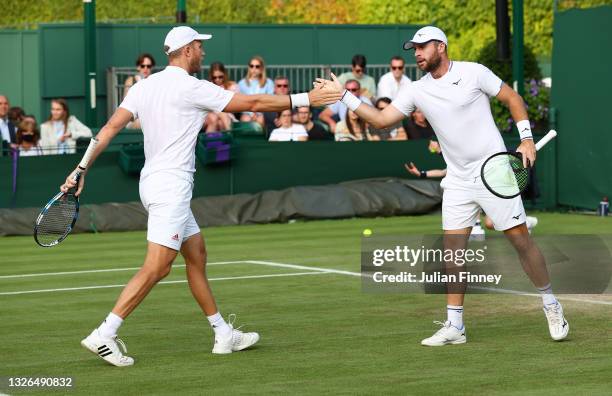 Luke Bambridge of Great Britain and Dominic Inglot of Great Britain during their men's doubles first round match against Stuart Parker of Great...