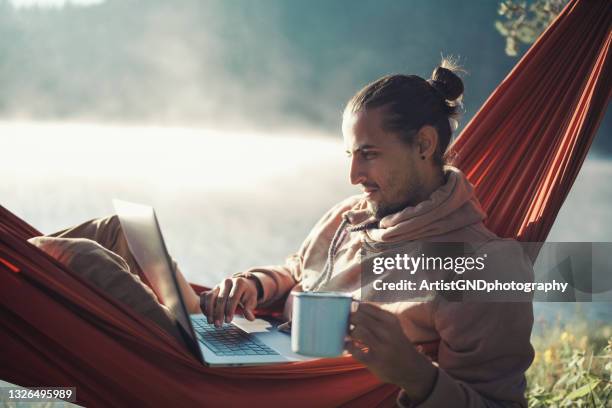 man using technology in nature. - tea outdoor stock pictures, royalty-free photos & images