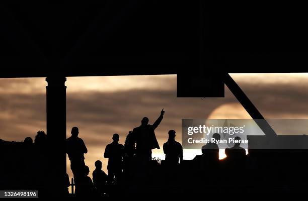 Member of the crowd cheers as the sun sets during the 2nd One Day International match between England and Sri Lanka at The Kia Oval on July 01, 2021...