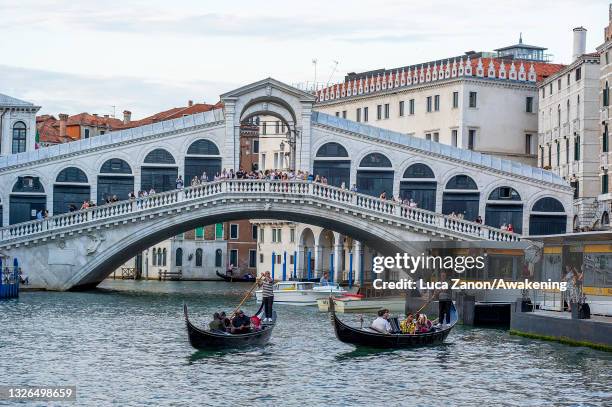 Russell Wilson and Ciara are seen during a gondola tour near the Rialto Bridge on July 01, 2021 in Venice, Italy.