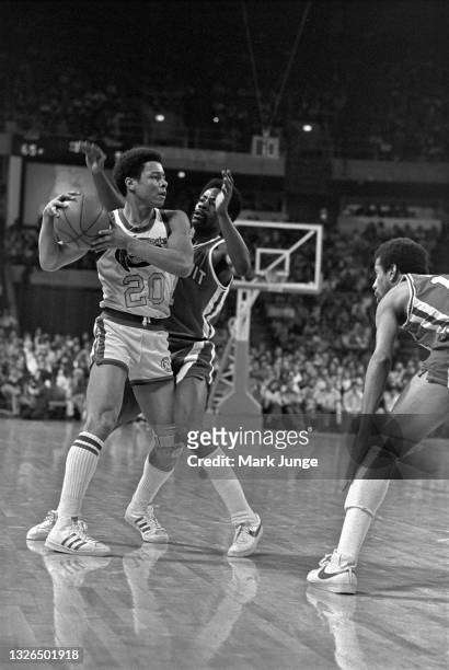 Denver Nuggets guard Mack Calvin holds the ball away from Detroit Pistons guard Kevin Porter, Sr. #1 during an NBA basketball game at McNichols Arena...