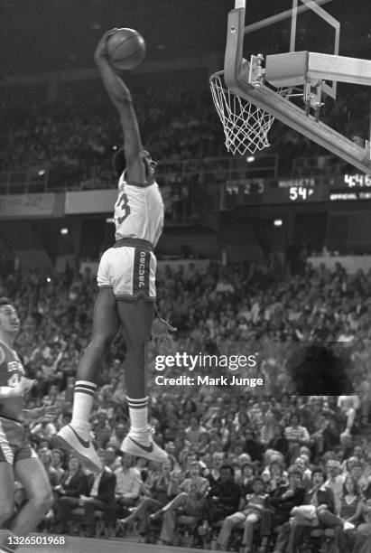 Denver Nuggets forward David Thompson sails toward the basket for a slam dunk during an NBA basketball game against the Detroit Pistons at McNichols...