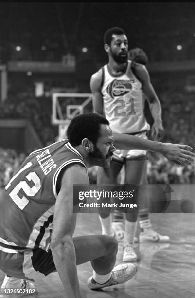 Detroit Pistons guard Phil Sellers picks himself up from the floor during an NBA basketball game against the Denver Nuggets at McNichols Arena on...