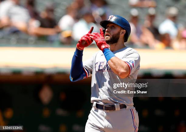 Joey Gallo of the Texas Rangers reacts after he hit a two-run home run in the fifth inning against the Oakland Athletics at RingCentral Coliseum on...