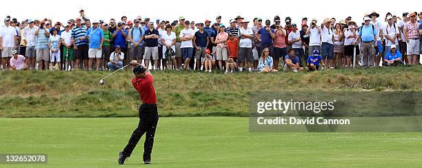 Tiger Woods of the USA hits his second shot on the par 5, 8th hole during day four of the 2011 Emirates Australian Open at The Lakes Golf Club on...