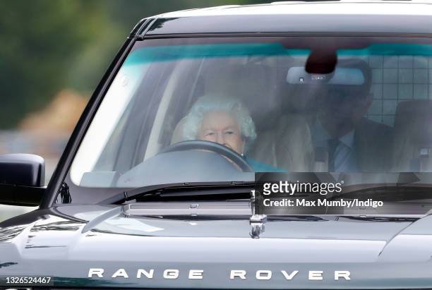 Queen Elizabeth II seen driving her Range Rover car as she attends day 1 of the Royal Windsor Horse Show in Home Park, Windsor Castle on July 1, 2021...