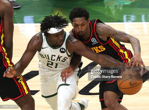 Jrue Holiday of the Milwaukee Bucks steals the ball form Lou Williams of the Atlanta Hawks during the first half in Game Five of the Eastern...