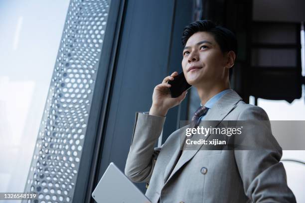 businessman talking on the mobile phone - business talk stock pictures, royalty-free photos & images