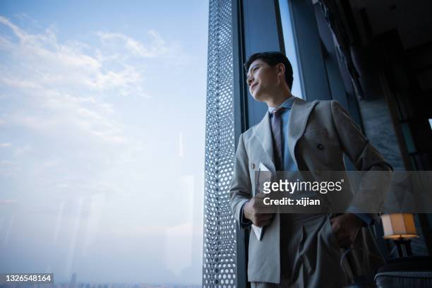 businessman looking through window - asian business man bildbanksfoton och bilder