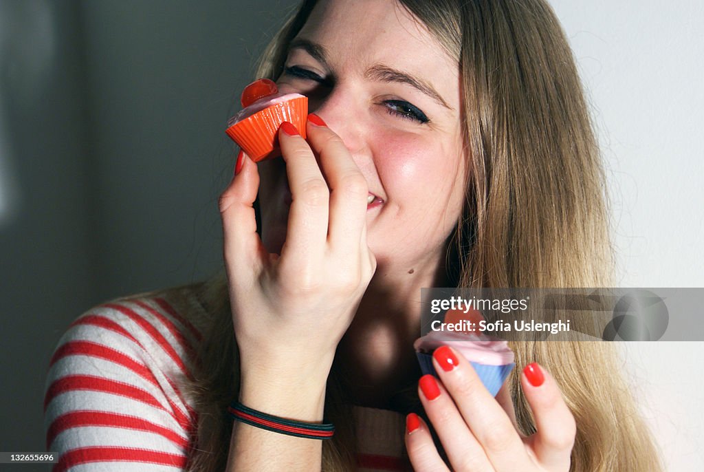 Woman eating cupcake