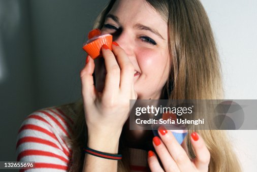Woman eating cupcake Woman eating cupcake