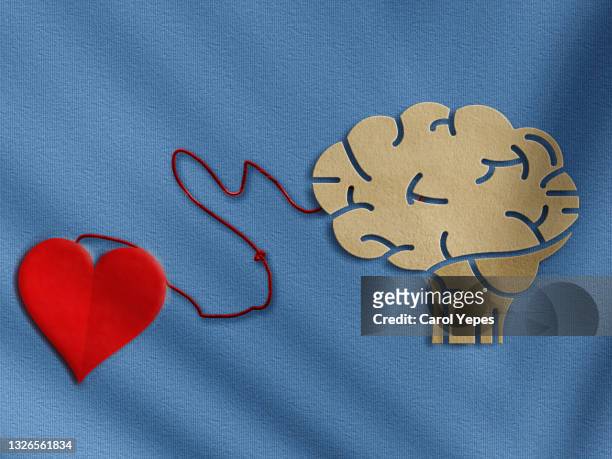 brain and red heart connected.emotional intelligence concept in paper cut - heart vs mind stock pictures, royalty-free photos & images