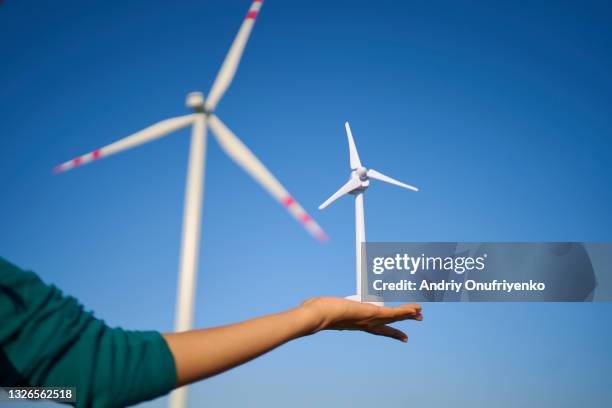 hand holding wind turbine prototype model miniature. - small wind turbine stockfoto's en -beelden