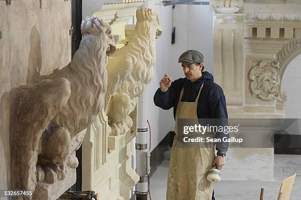 Stone sculptor Peik Wuensche eyeballs and original as he prepares to chisel refinements into an eagle that will be an exhibit piece at the...