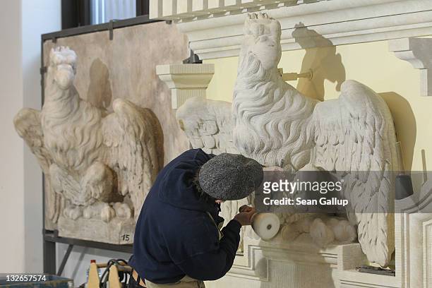 Stone sculptor Peik Wuensche chisels refinements into an eagle that will be an exhibit piece at the Schlossbauhuette studio, where Wuensche and a...