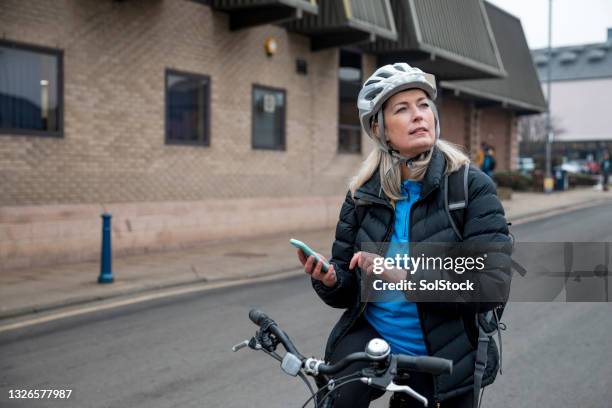 checking her phone map - circular economy stock pictures, royalty-free photos & images