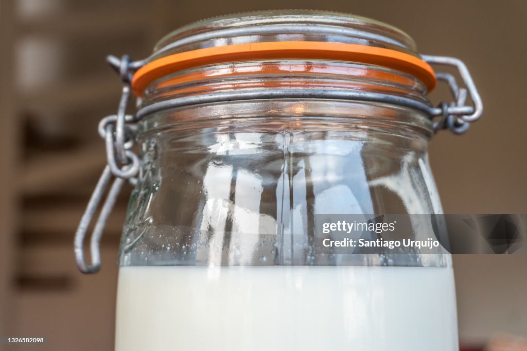 Close-up of glass jar filled with kefir