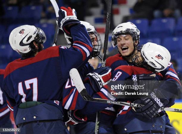 Team USA celebrates after Austin Cangelosi scored the puck on Mathias Israelsson of Sweden at World Junior A Challenge at Langley Events Center on...