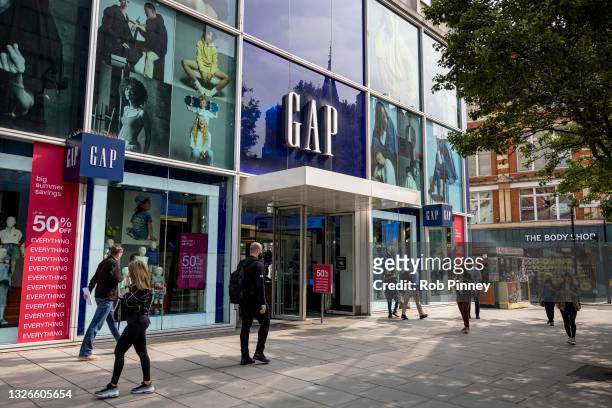 People walk past the Gap flagship Oxford Street store on July 02, 2021 in London, England. The clothing company will close 81 stores in Britain and...