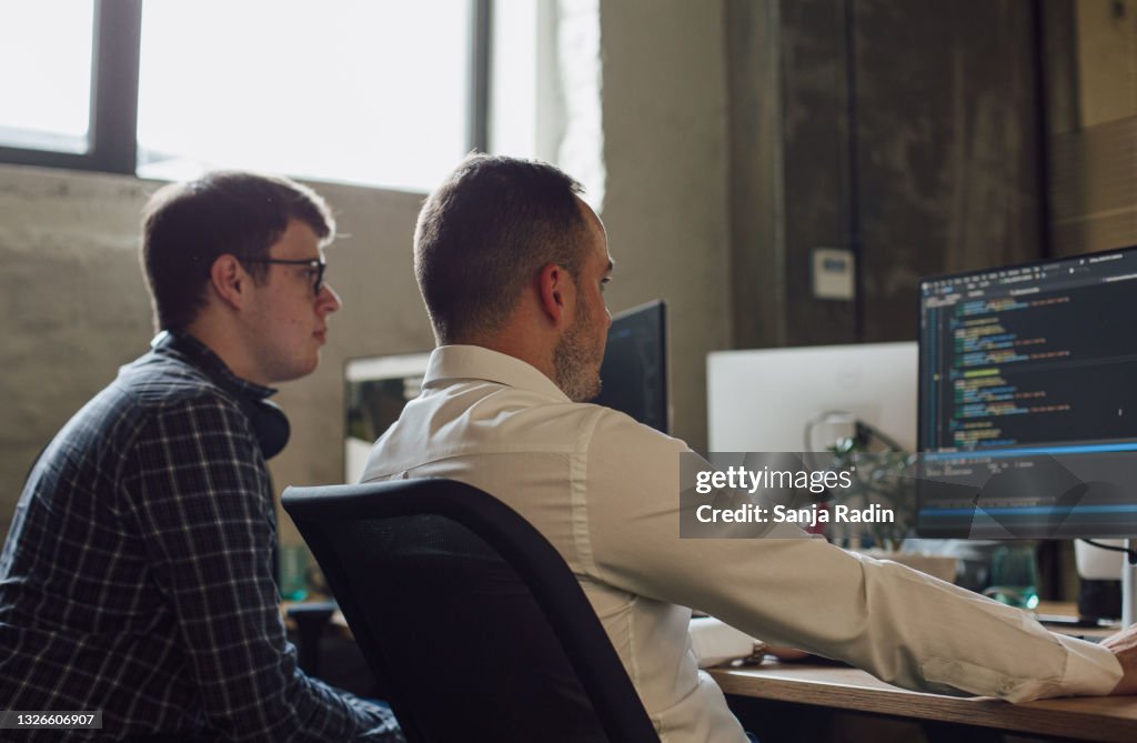 Hugging The Programming Computer Two Programmer Sitting In Front Of Computer High-Res Stock Photo ...