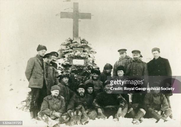 Photograph by Bertram Clegg, wireless operator on the Quest expedition, of the crew next to the Shackleton memorial cairn and cross at Hope Point in...