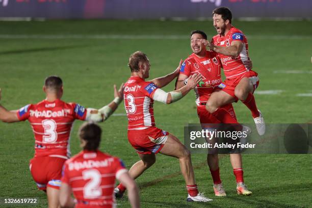 Corey Norman of the Dragons celebrates the win from his field goal with his team mates during the round 16 NRL match between New Zealand Warriors and...