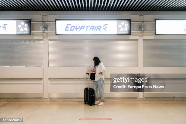 Woman with her suitcase at the Egyptair stand in terminal T1 of Adolfo Suarez Madrid-Barajas Airport on the first day of the first 'Operation...